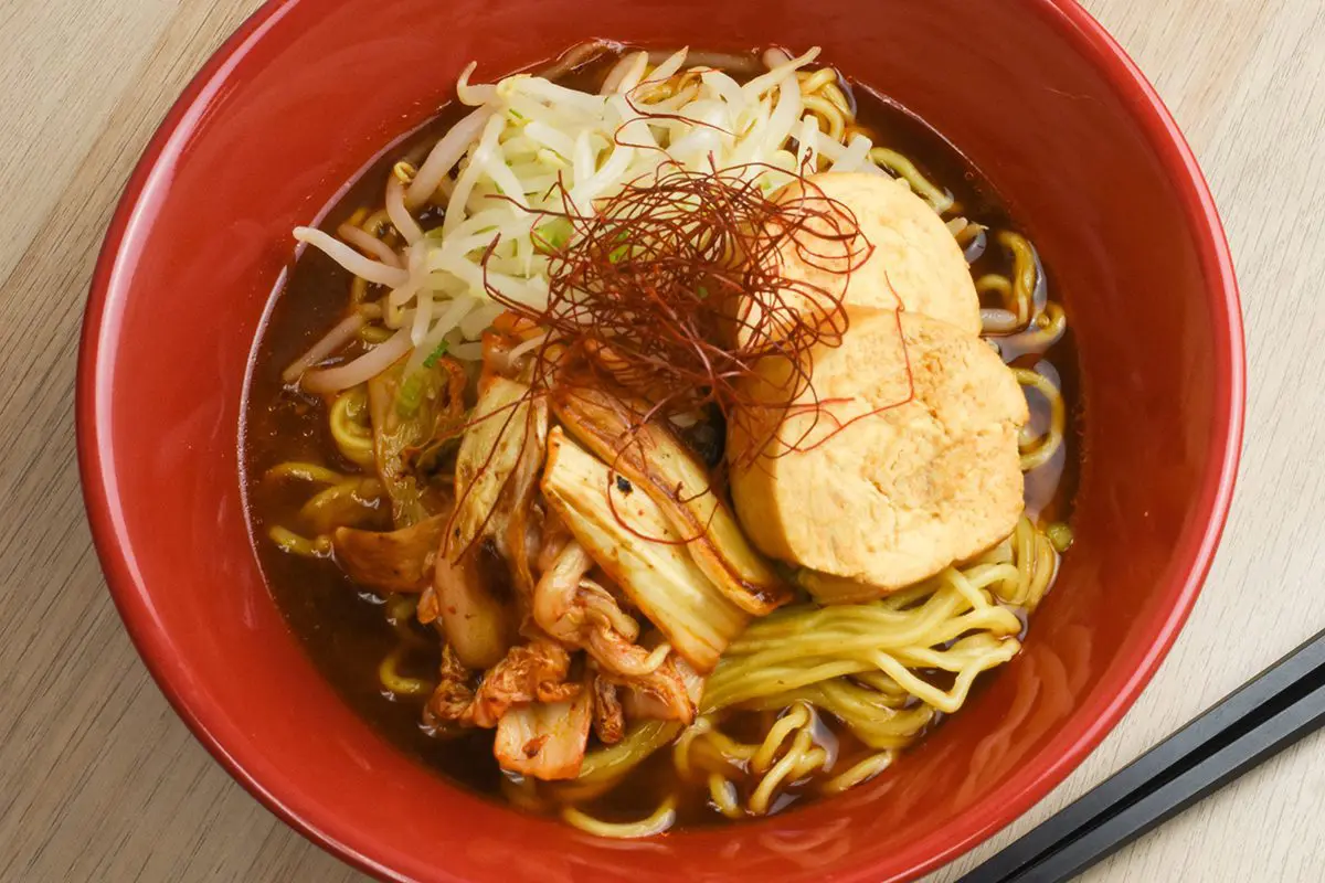 Premium Garlic Miso Ramen topping with chicken chashu, stir-fried kimchi, and bean sprout namul (seasoned bean sprouts)