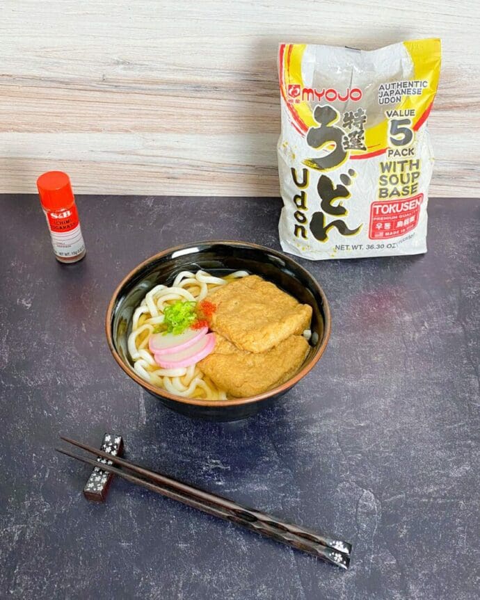 Kitsune Udon topped with kamaboko (fish cake), scallions, and oage simmered aburaage (deep-fried tofu pouches)