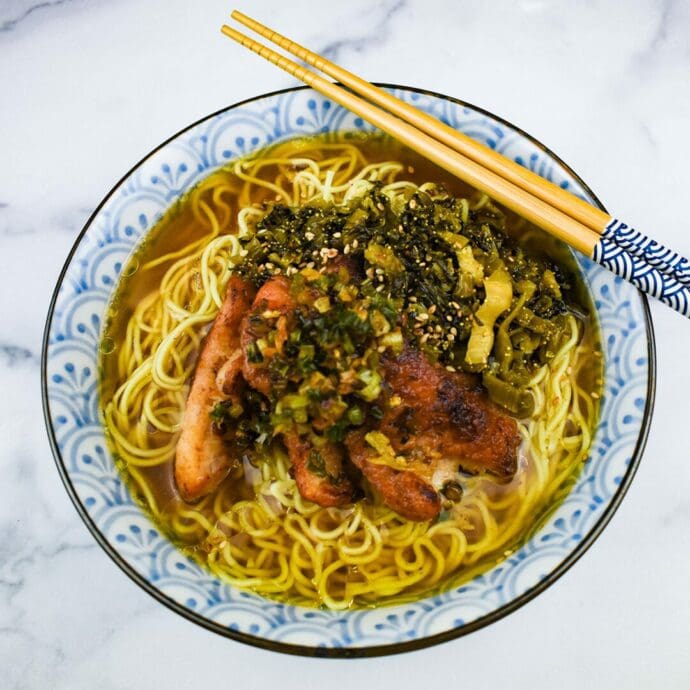 Blackened green onion and oil on top of ramen