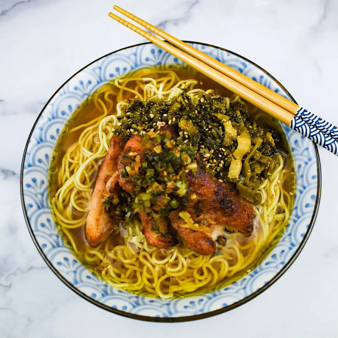 Blackened green onion and oil on top of ramen