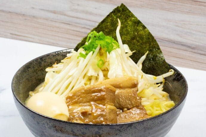 Myojo-style Jiro Ramen made with Premium Seafood Tonkotsu Ramen with a fatty pork broth, thick cuts of chashu pork, and a mountain of bean sprouts