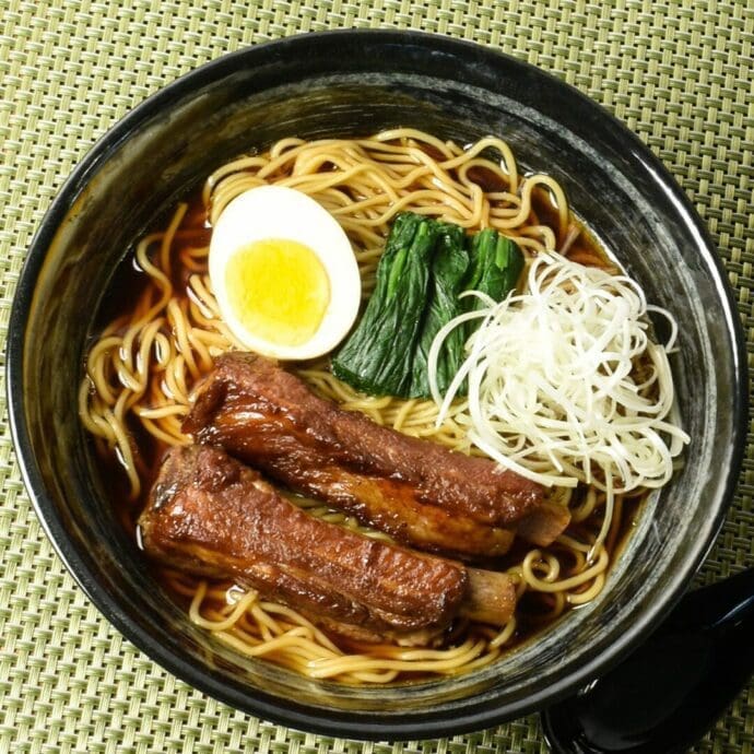 Signature Shoyu Ramen with spare ribs using pressure cooker topping with spinach, egg, and scallion