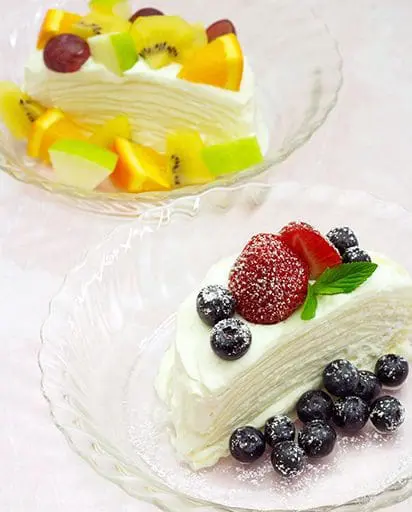 Gyoza mille crepe, layering the wrappers with cream, topped with seasonal fruits such as strawberry, blueberry, and grape