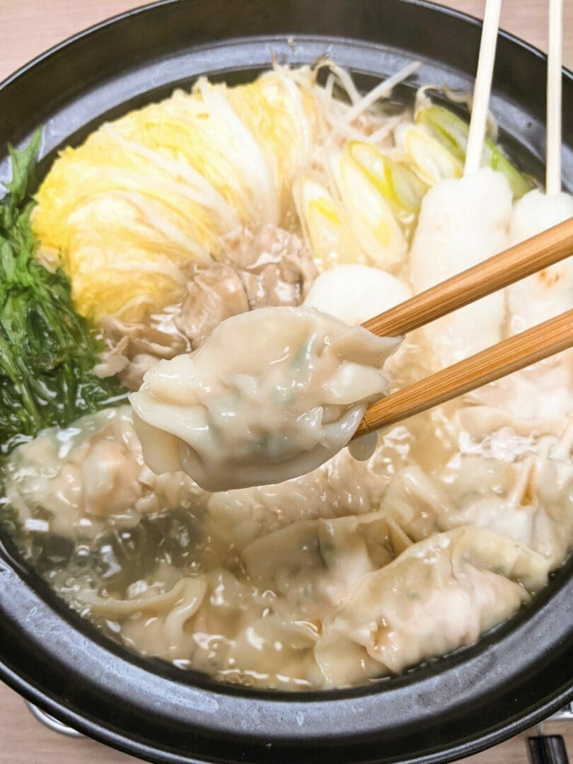 Gyoza hotpot with kiritanpo (pounded rice cake), nappa cabbages, bean sprouts, maitake mushrooms, green onions, and mizuna