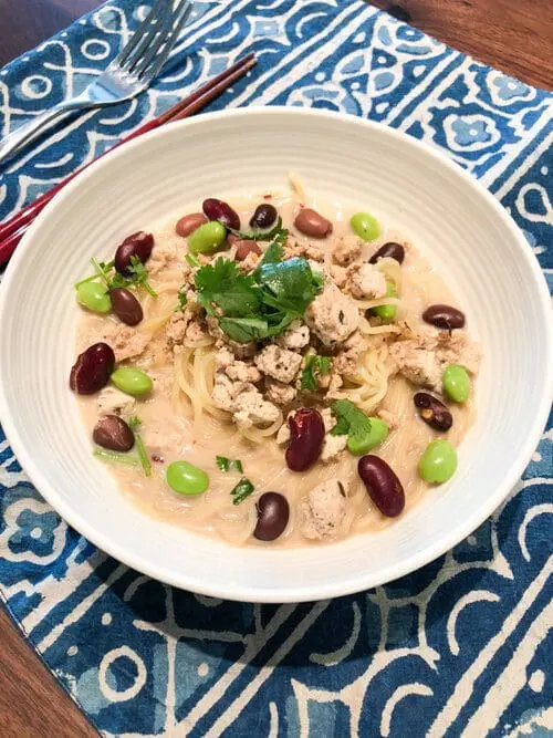 Signature Tonkotsu Ramen with healthy tofu and beans with sesame oil, soy sauce, and chili powder