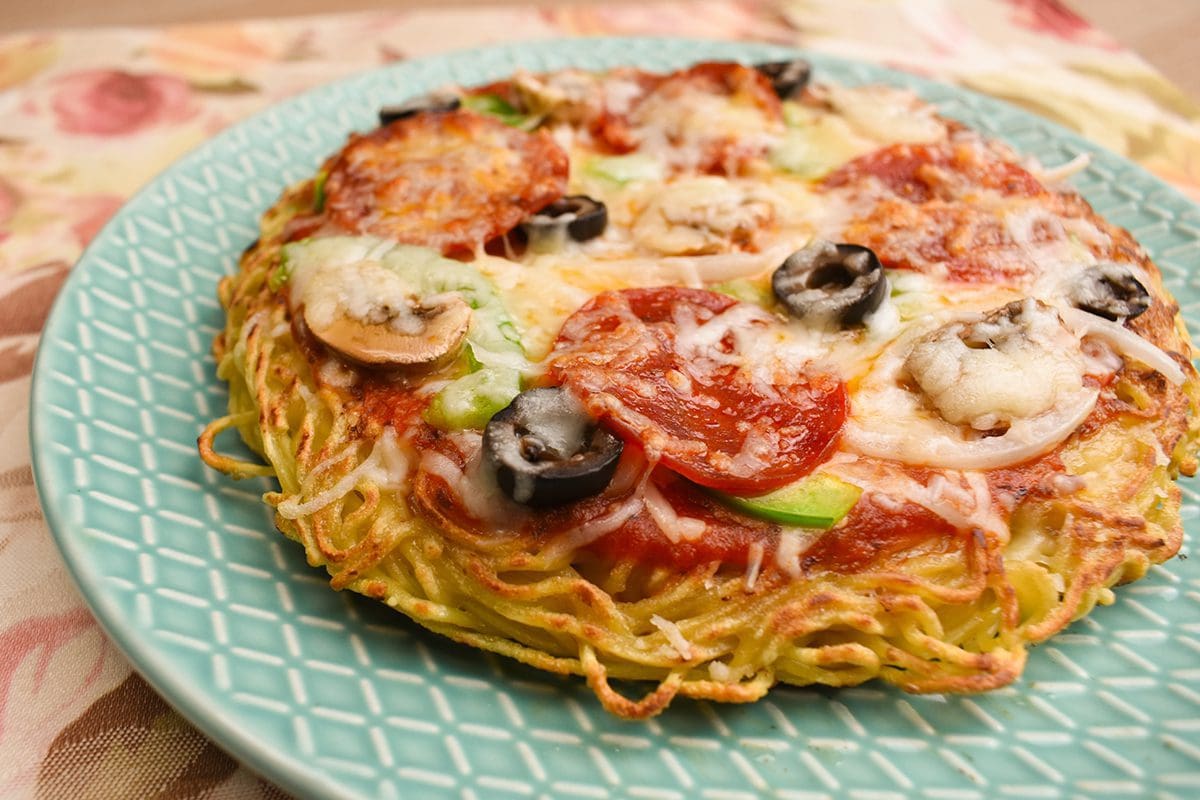 Ramen Pizza made with Signature Tonkotsu Ramen topping with bell pepper, onion, pepperoni, black olives, mushroom, and mozzarella cheese