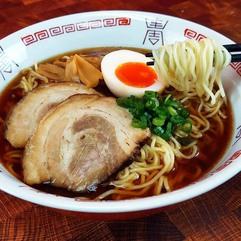 Basic shoyu ramen topping with chashu pork, ajitsuke tamago (marinated egg), green onions, and braised bamboo shoot