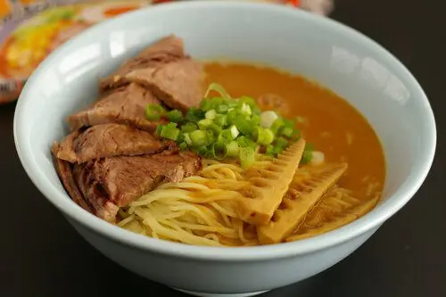 Signature Miso Ramen with a thick hearty soup (Kotteri) topping with roasted beef brisket and homemade menma (bamboo shoots)