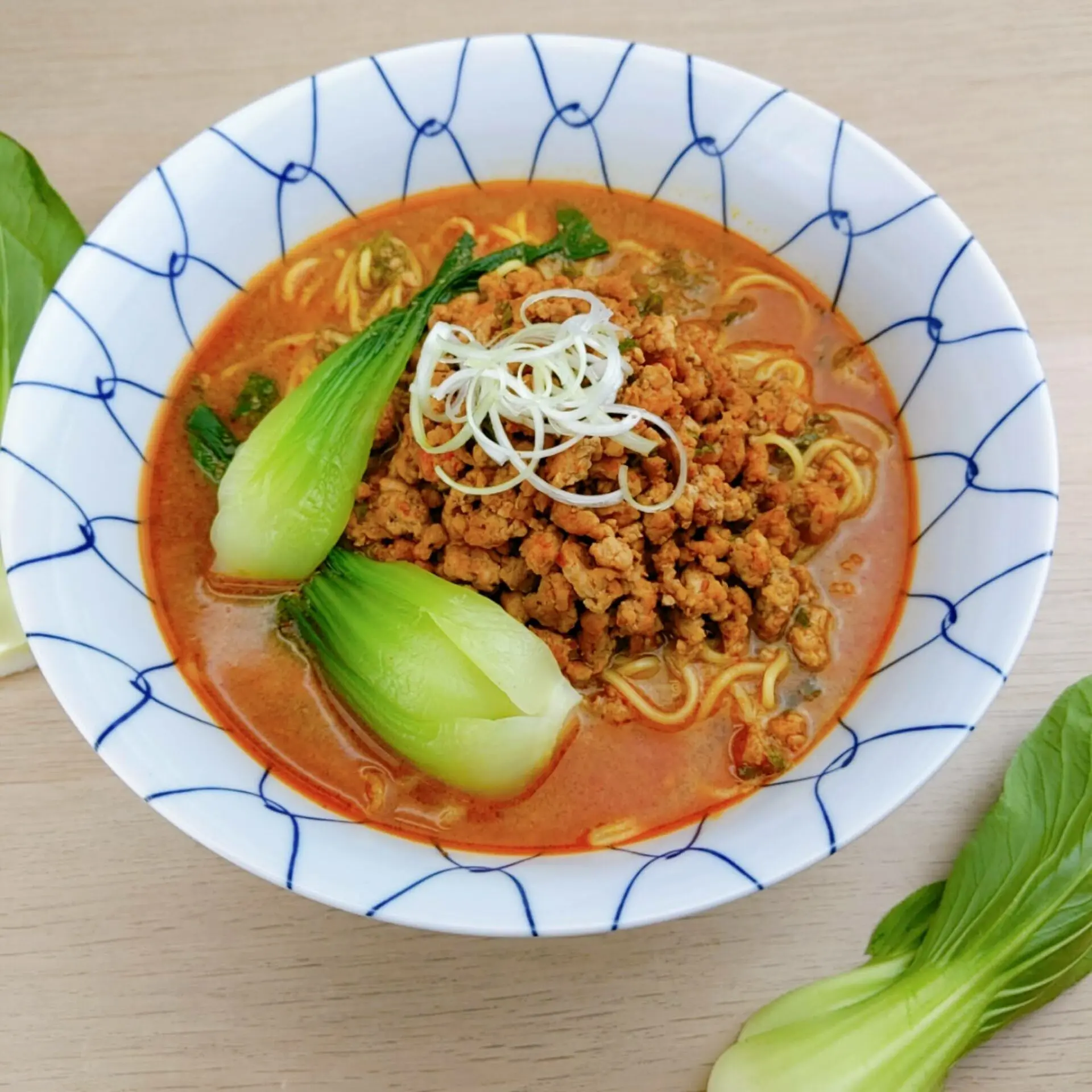 Myojo-style Tantanmen made with Signature Spicy Miso Ramen using peanut butter topping with sliced green onions and bok-choy