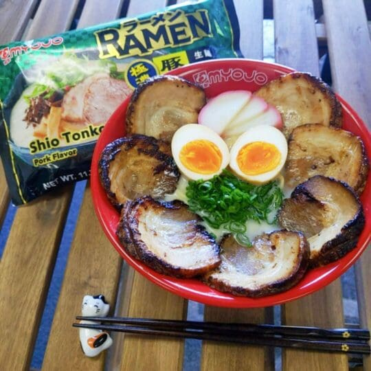 Shio Tonkotsu Ramen with plenty of chashu topping with ajitsuke tamago (marinated egg), spring onions, and kamaboko (fish cake)