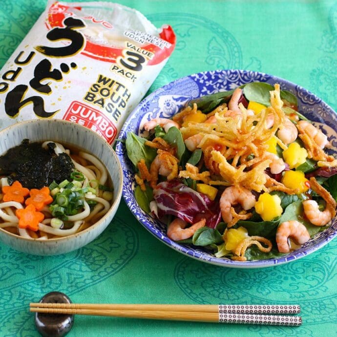 A small bowl udon serving with a crispy fried udon salad topping with shrimp and paprika