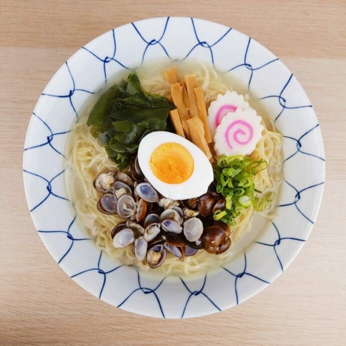 Ramen with soup from the shijimi clams and chicken bouillon powder topping with ajitsuke tamago (marinated egg), wakame seaweed, naruto (fish cake), menma (bamboo shoots), and green onion