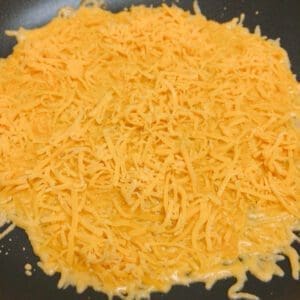 Crispy-Cheese-Curry-Yakisoba - Step 3 sprinkle cheese over the pan. Make a thin layer of cheese