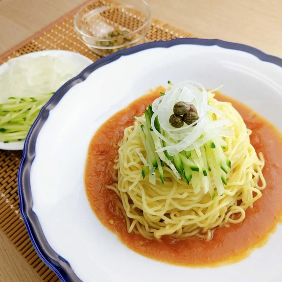 Hiyashi Chuka with tomato sauce topped with cucumber, onions, and capers