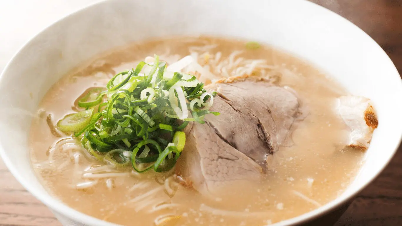 Ramen noodles served in a white bowl