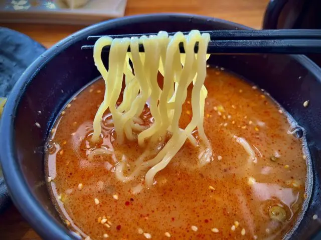 Dipping the noodles in the tsukemen dipping sauce