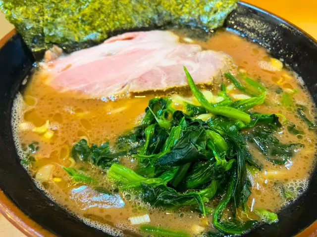 Spinach served on top of ramen noodles